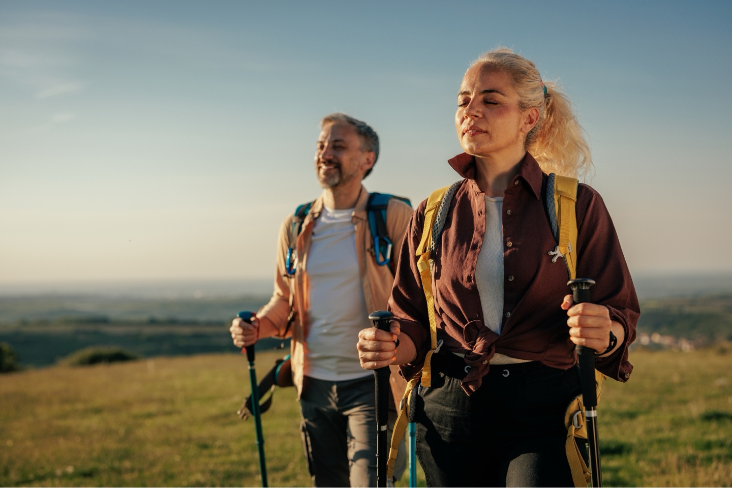 Couple hiking outdoors with trekking poles