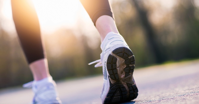 Close-up of running shoes jogging on pavement